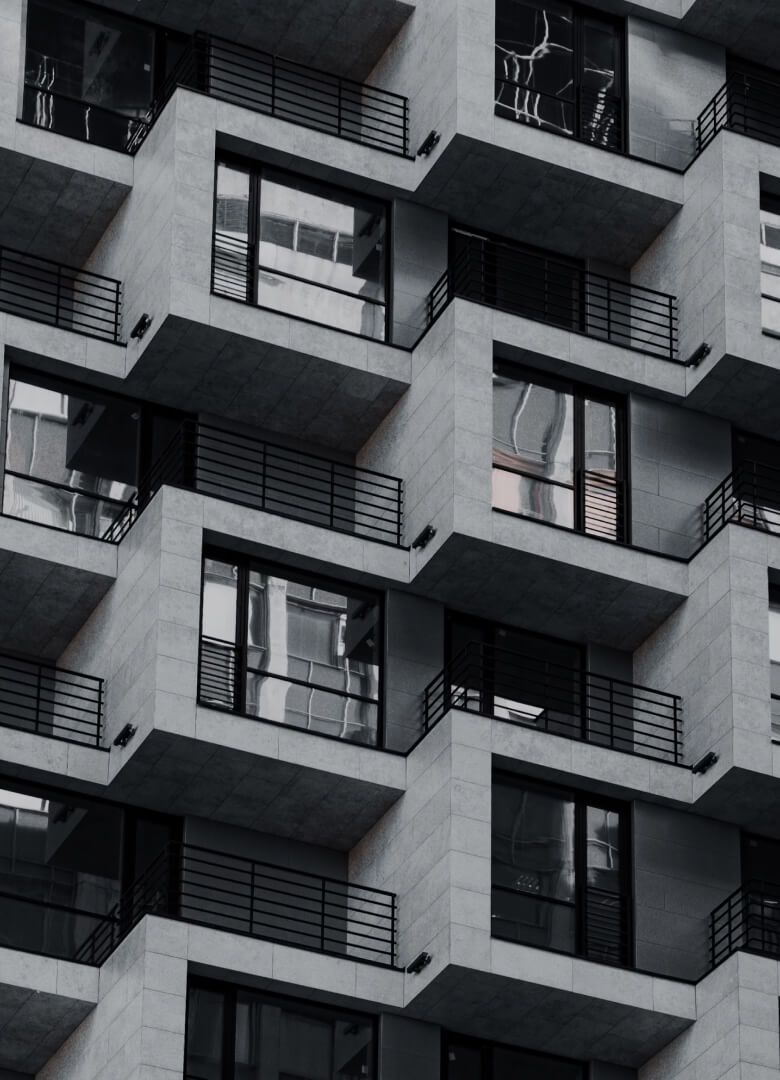 Geometric building facade with repeating balconies and black railings, urban architecture - Neutrinos