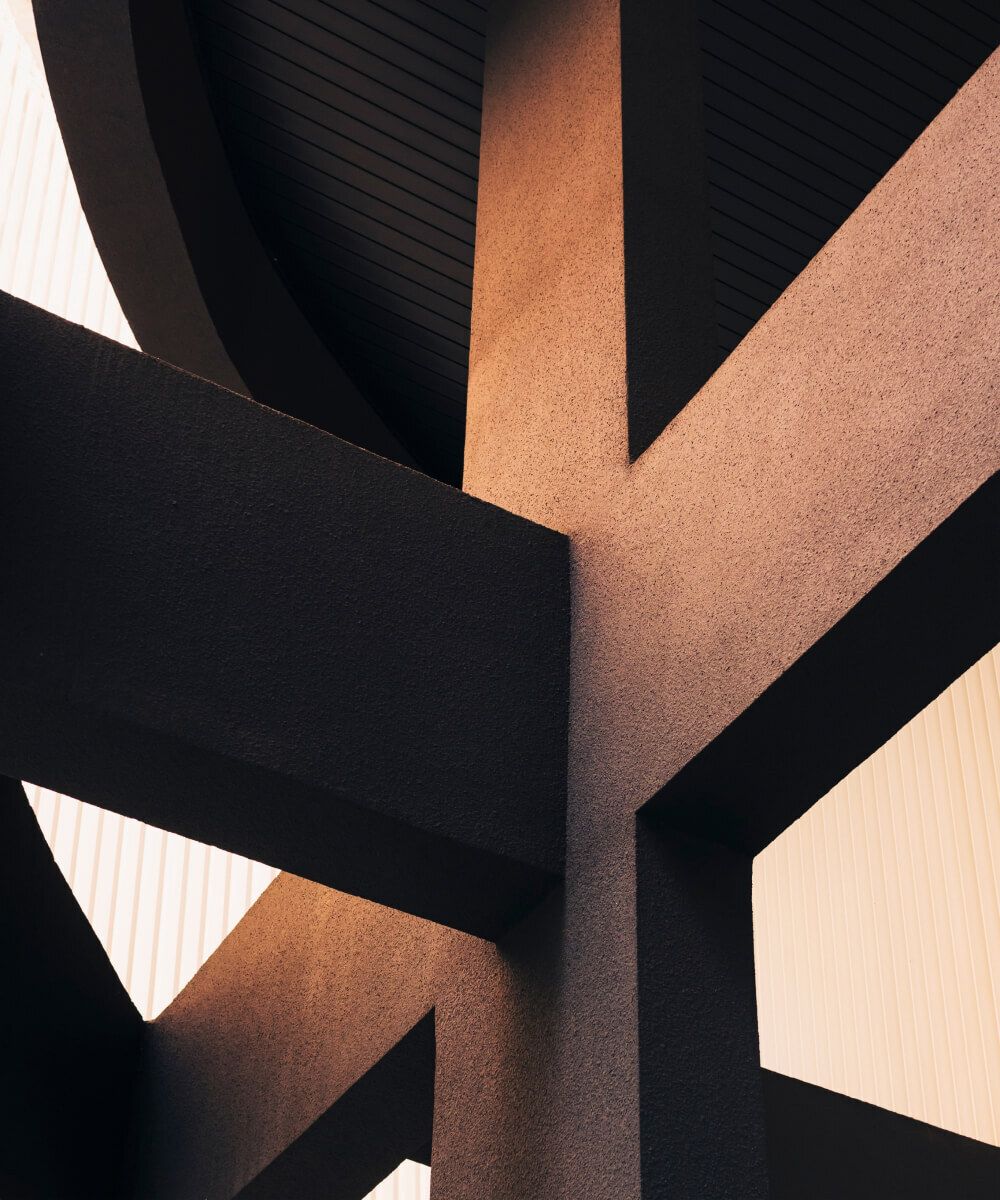 Abstract architectural structure with intersecting beams and warm lighting – Neutrinos.