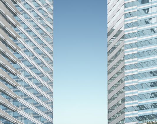 Modern glass buildings against a clear blue sky-Neutrino