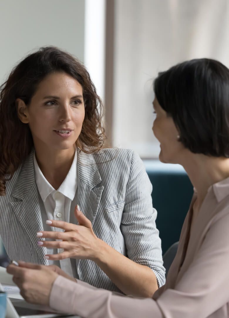 Two businesswomen in discussion during a professional meeting - Neutrinos
