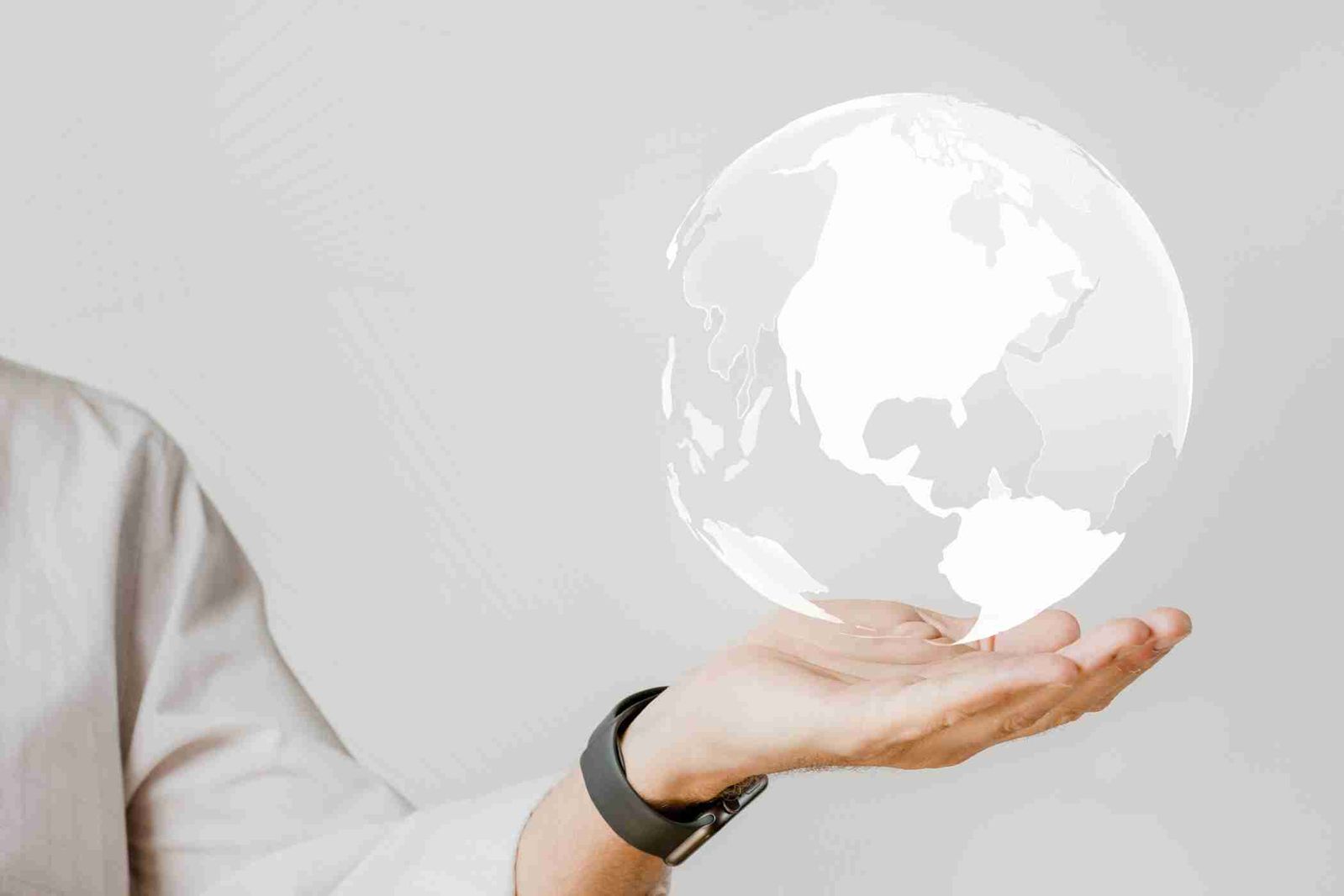 Hand holding a digital transparent globe representing global connectivity and innovation – Neutrinos.