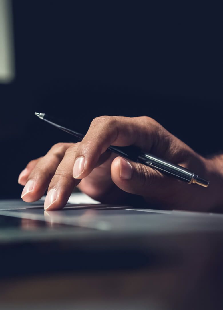 Close-up of hand using a pen on a digital tablet in low light – Neutrinos