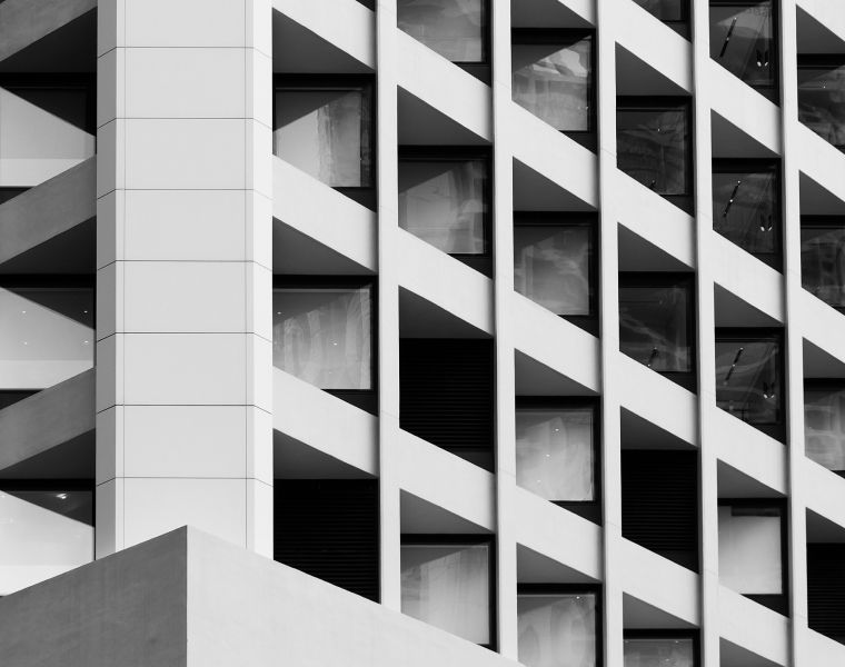 Modern building facade with repeating diagonal window pattern in black and white architecture - Neutrinos