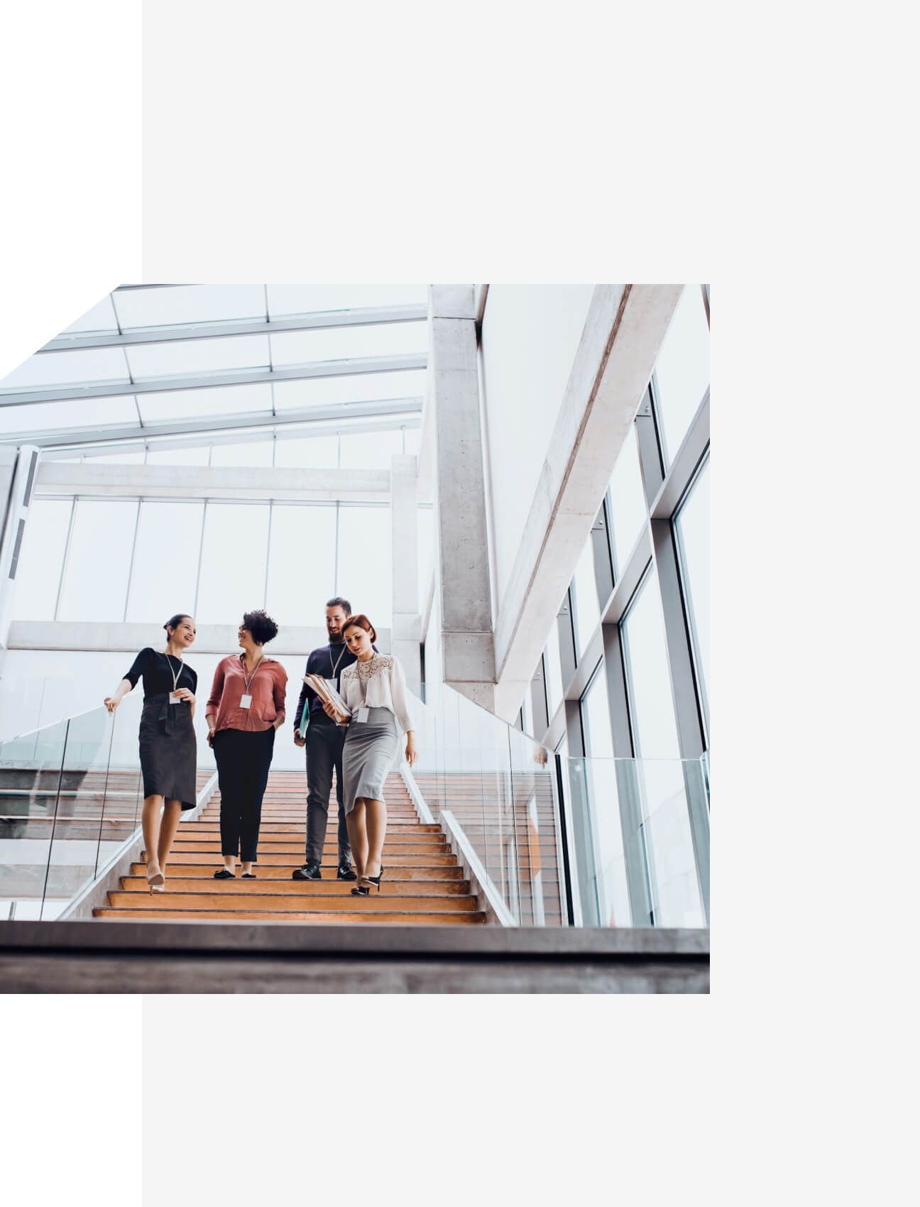 Business team walking down modern office stairs – Neutrinos