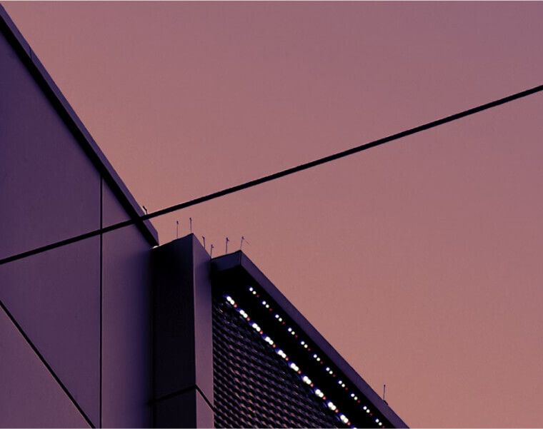 Contemporary building facade against a purple dusk sky, evoking modernity – Neutrinos