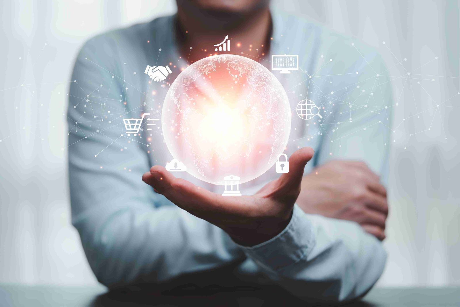 Man holding glowing digital sphere with business icons, symbolizing connected ecosystems and digital innovation - Neutrinos