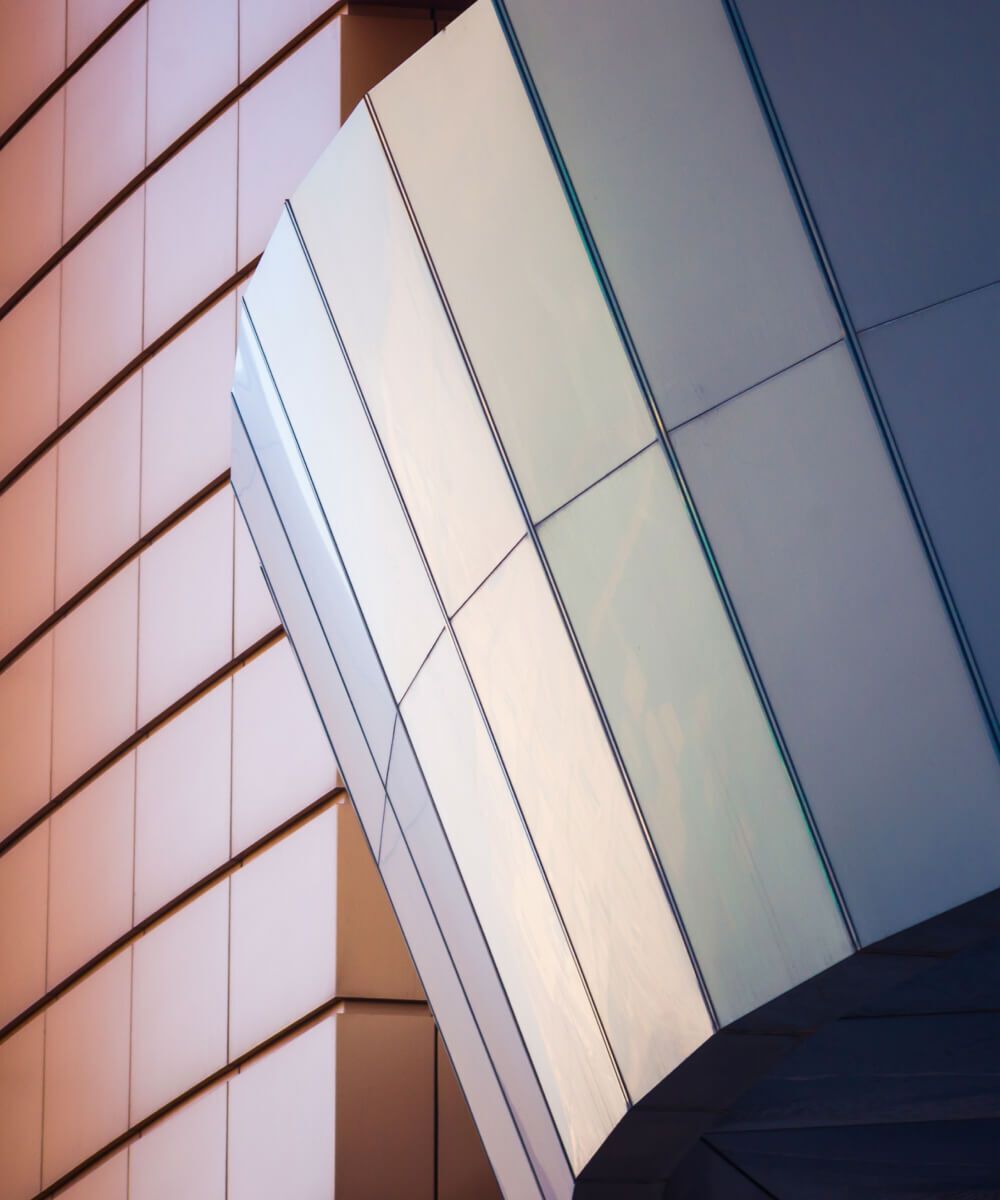 Modern curved building facade with reflective glass panels – Neutrinos