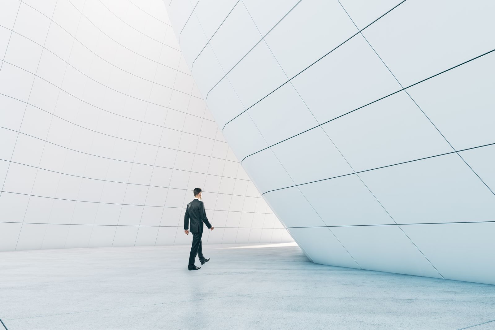 Man walking in abstract glass building open space interior